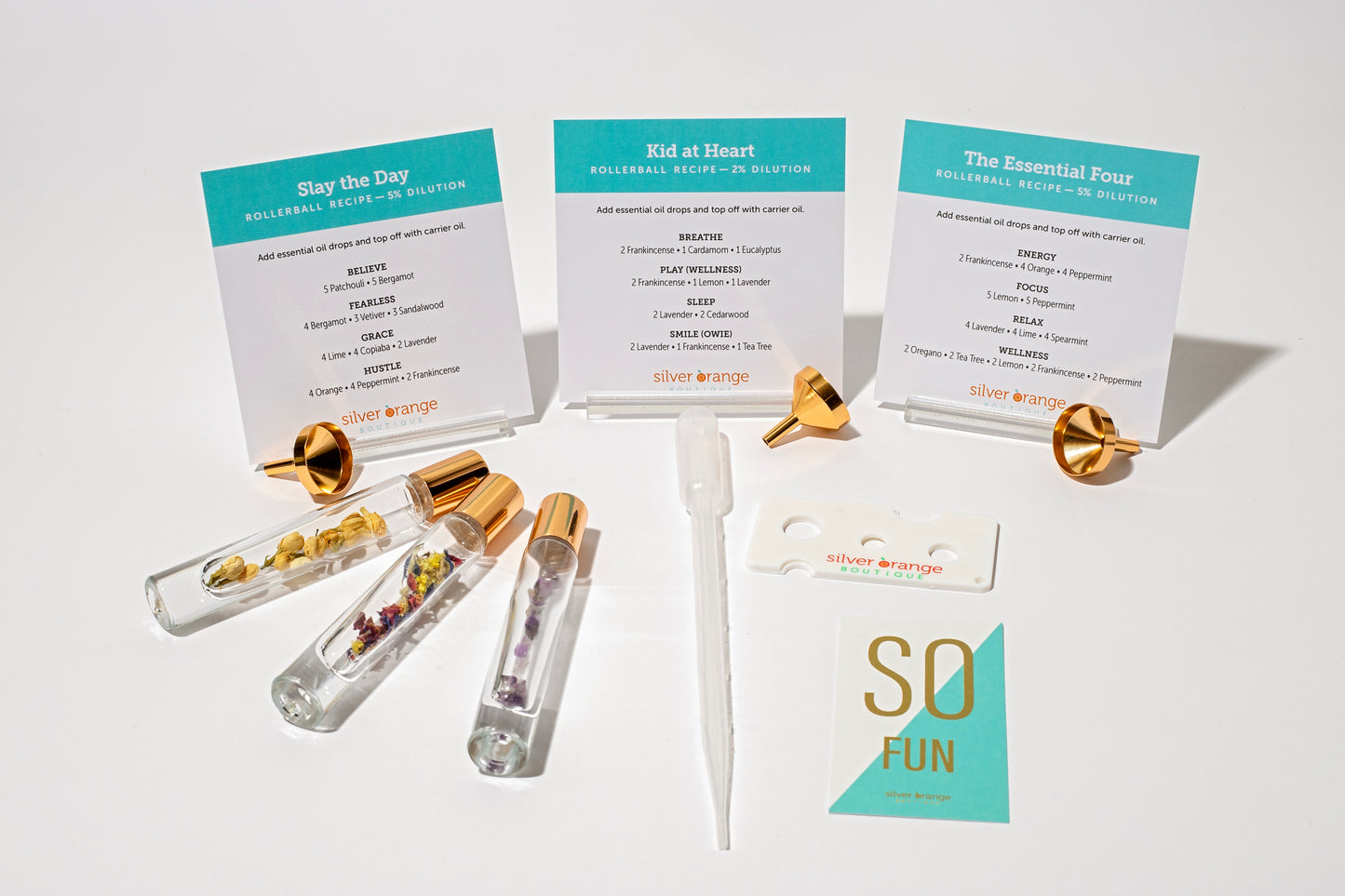 3 Glass roller bottles with organic flowers and crystals with recipe cards for essential oil blends