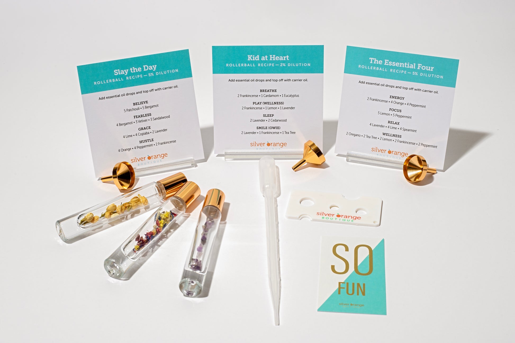 3 Glass roller bottles with organic flowers and crystals with recipe cards for essential oil blends