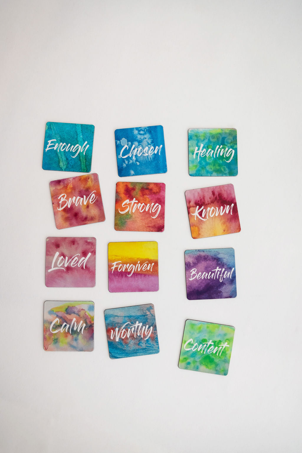 12 mini affirmation magnets grouped together on a white background