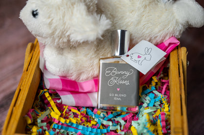 Bunny Kisses essential oil blend in a bottle in an Easter Basket with white bunny and colorful paper shreds